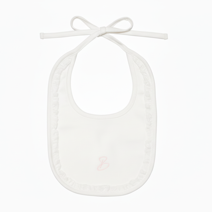 Cream baby bib with pink monogram