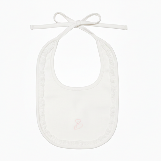 Cream baby bib with pink monogram